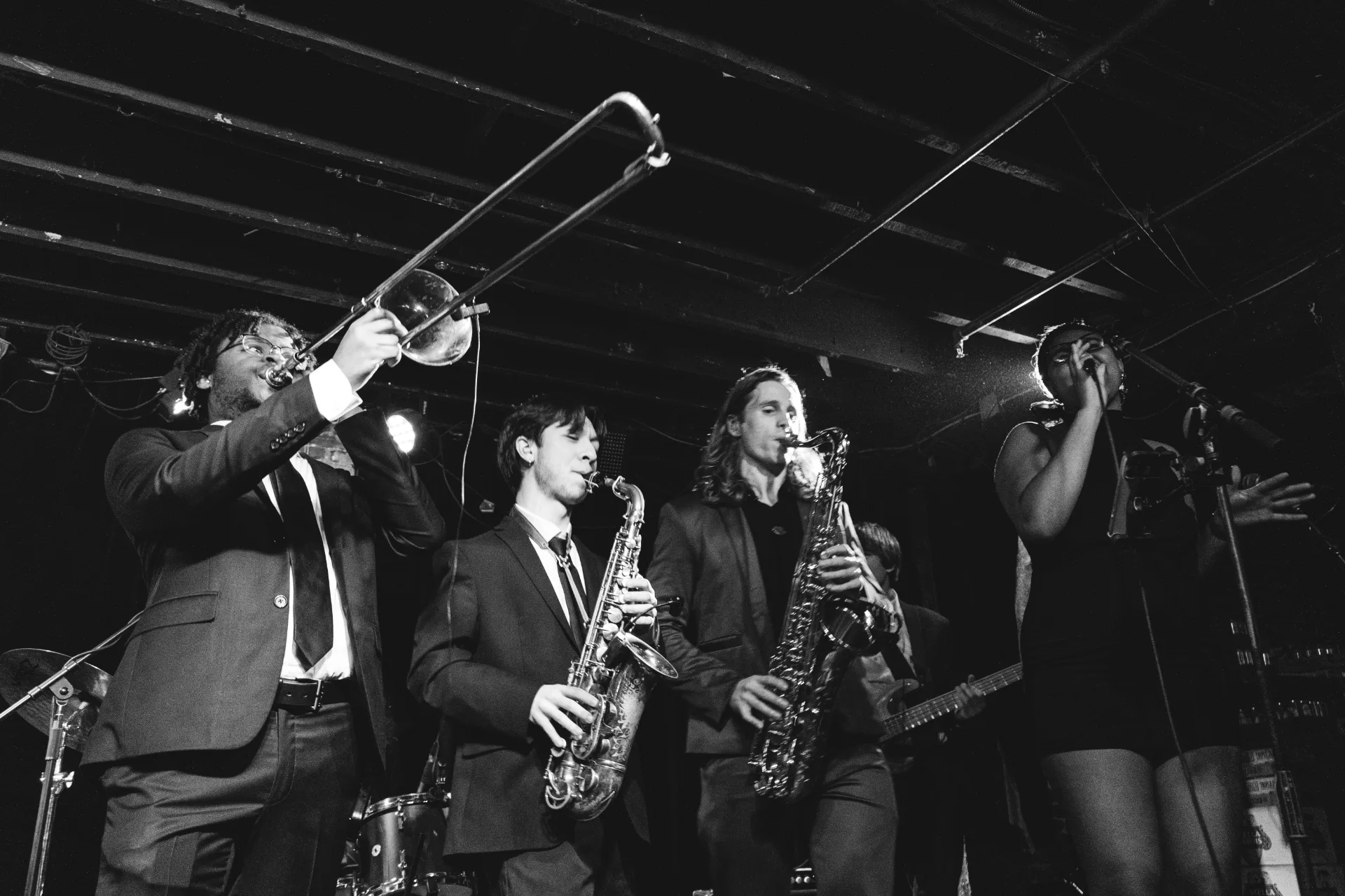 The whole band lined up across the stage mid-performance